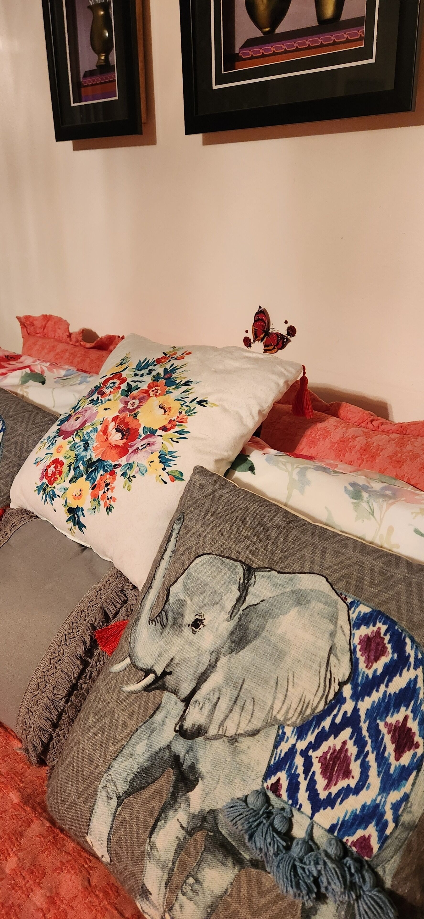 A bed with multiple pillows, each featuring different designs.