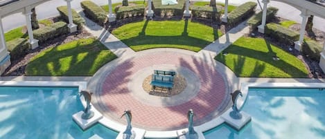 A circular pool with a central seating area and a sign reading "Emerald Island".