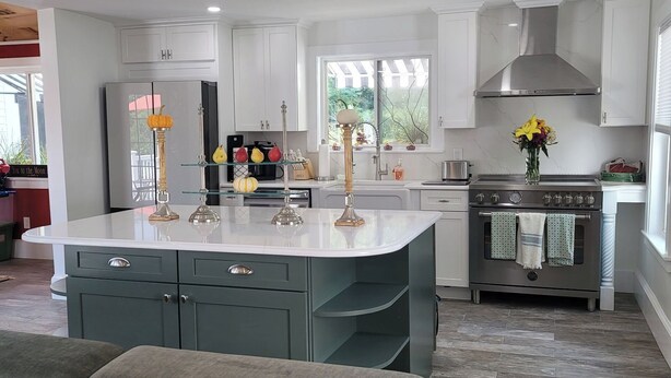 A modern kitchen with white cabinetry, a central island, and a built-in oven. - Islesboro Suite in the Inn at Starlight Lodge (Maine)