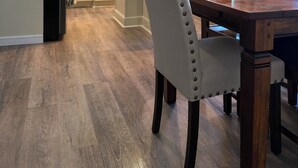 A modern kitchen with white cabinets, a black refrigerator, and a wooden dining table with chairs. - Spacious 4-bedroom house in charming Ephrata (Ephrata)