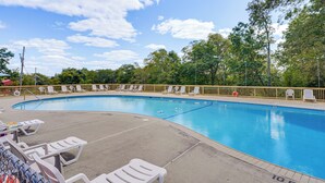 A swimming pool with lounge chairs and a fence. - Poconos Family Home w/ Game Room + Community Perks (East Stroudsburg)