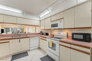 A kitchen with a microwave, oven, and dishwasher.