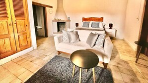 A living room with a sofa, a round coffee table, and a fireplace. - Hotel type room, one block from the Lake centr 5 (Valle de Bravo)