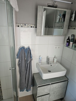 Shower, hair dryer, towels, soap