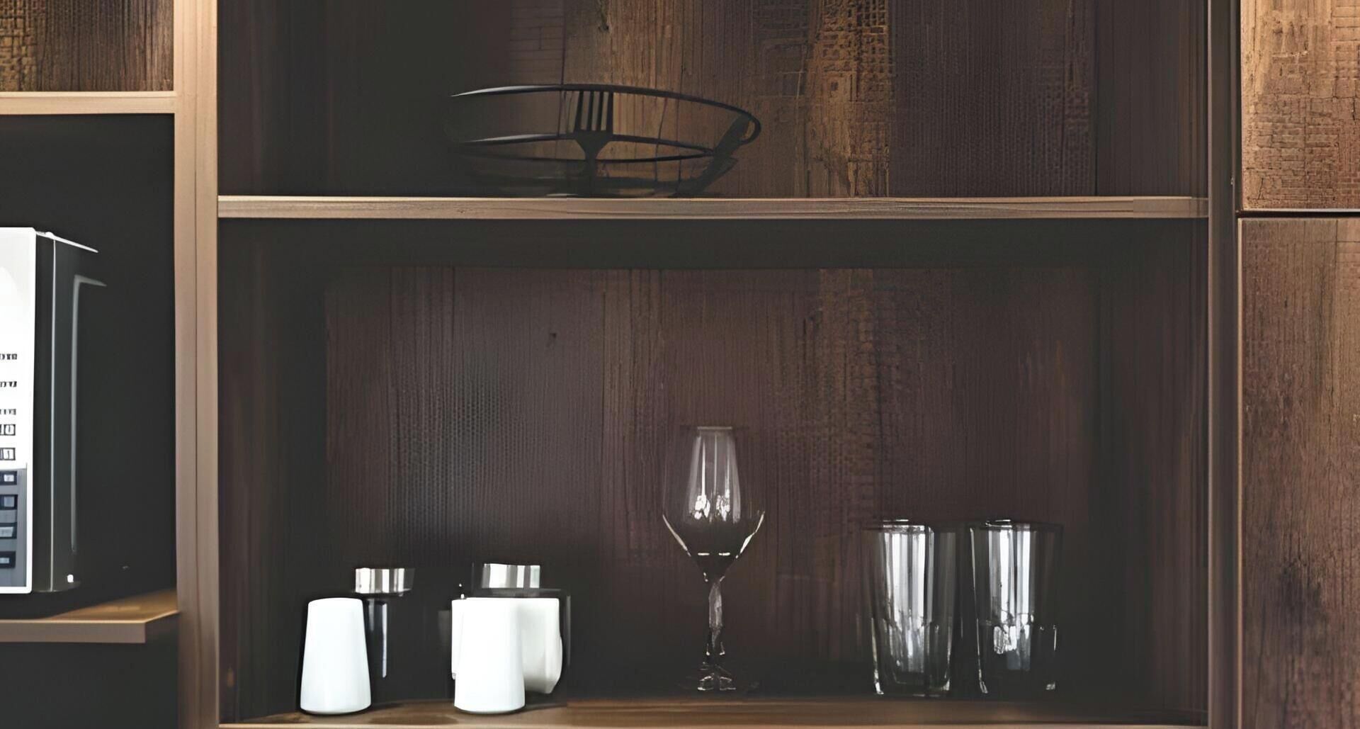 A wooden shelf with a wine glass, two tumblers, and three condiment containers.