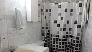 A bathroom with a sink, toilet, and shower curtain.