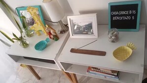 A desk with a framed photo, a small plant, a decorative shell, and a chalkboard sign.