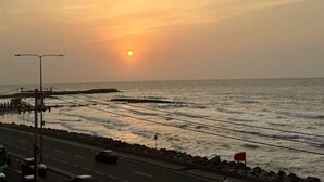 A coastal road with a sunset in the background. - @casa_grace Nice apartment with ocean view (Cartagena de Indias)