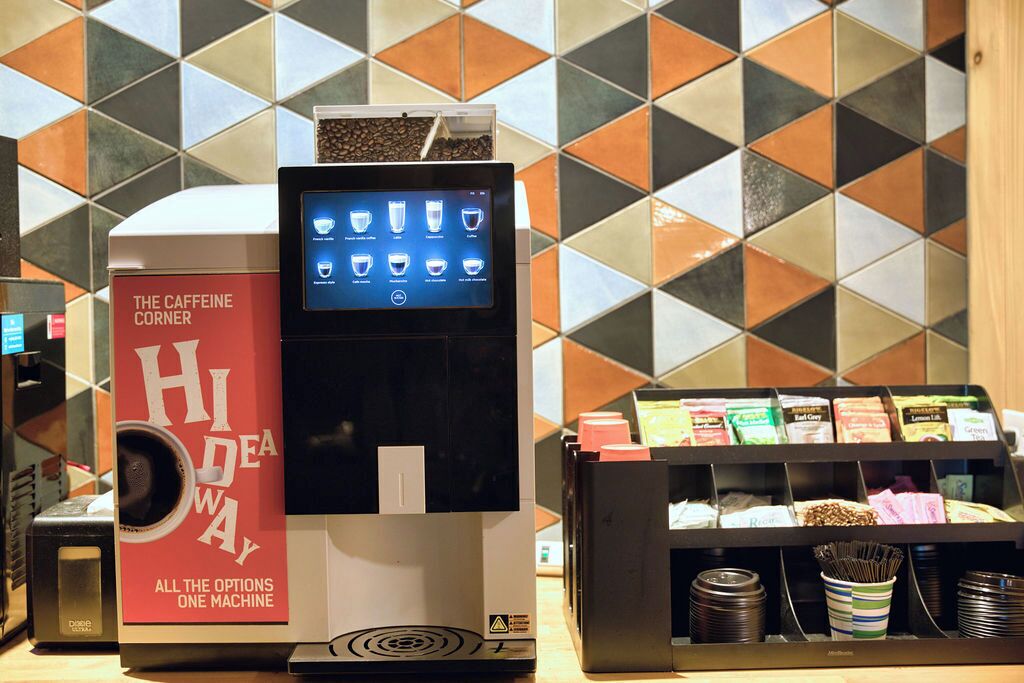 A coffee machine with a digital display and a coffee bean dispenser.