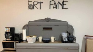 A kitchenette with a vintage refrigerator, a coffee maker, and a microwave. - Cottage Studio Suite # 1 (Fort Payne)