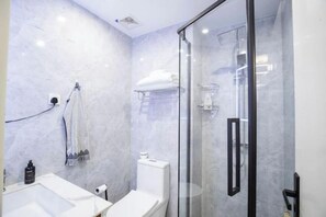 A modern bathroom with a glass shower enclosure, a white sink, and a towel rack. - Alba Garden Studio Luxe Hideout , Pool & Skyline (Nairobi)