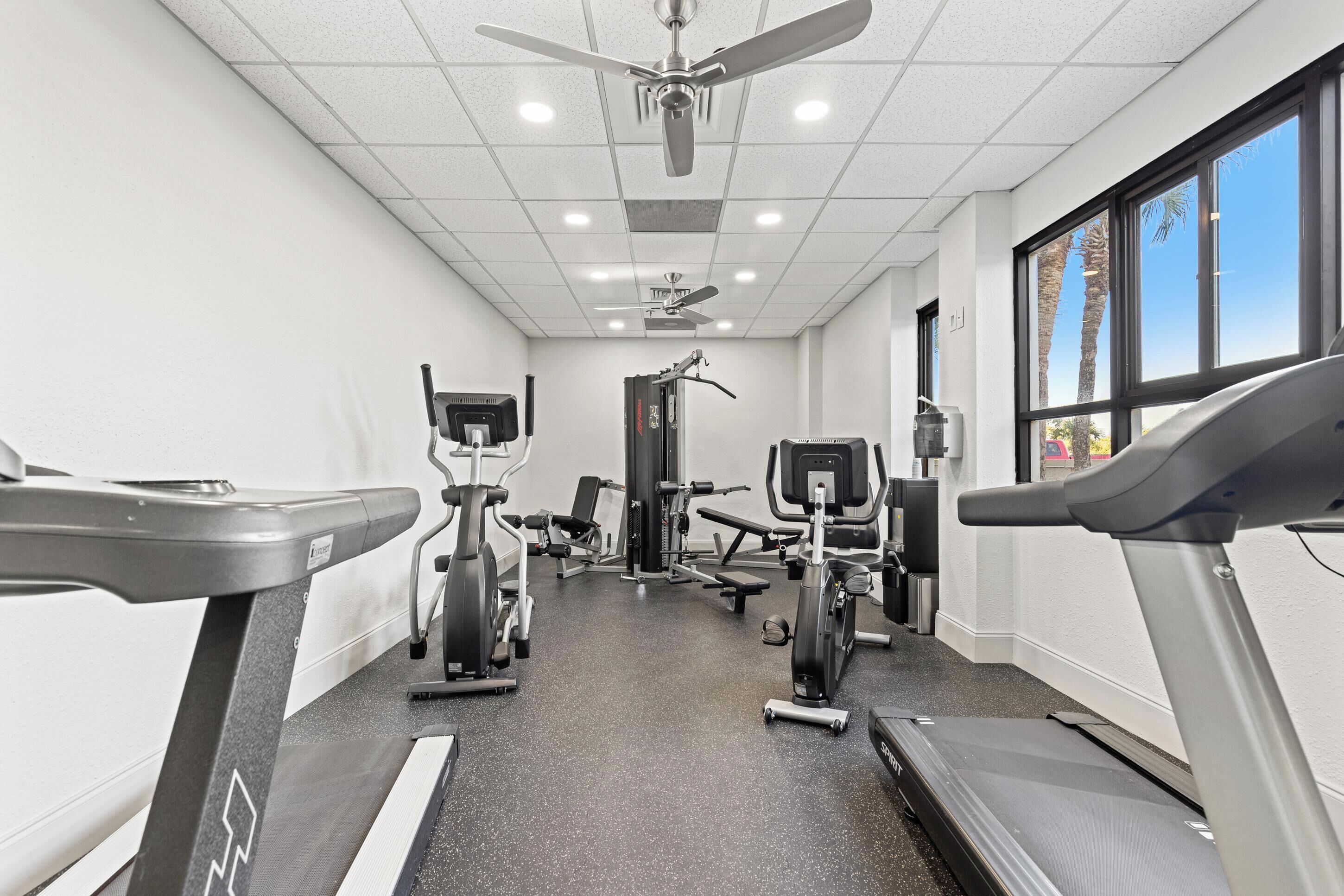 A gym with treadmills, exercise bikes, and weight machines.
