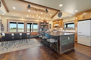 A spacious kitchen with a large island, wooden cabinets, and a view through the windows. - 1912 -D- Farmhouse Homestead (Nazareth)