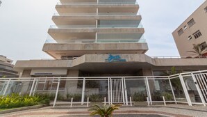A modern building with multiple floors, a glass facade, and a sign indicating it is a hotel.