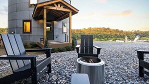 A rustic cabin with a wooden porch, outdoor seating, and a fire pit. - Luxe Silo w/ River Views <.5 mi to Downtown (Lynchburg)
