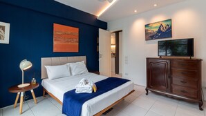 A modern bedroom with a bed, a dresser, and artwork on the walls. - House overlooking Rodrigo de Freitas Lagoon | VR2 (Rio de Janeiro)