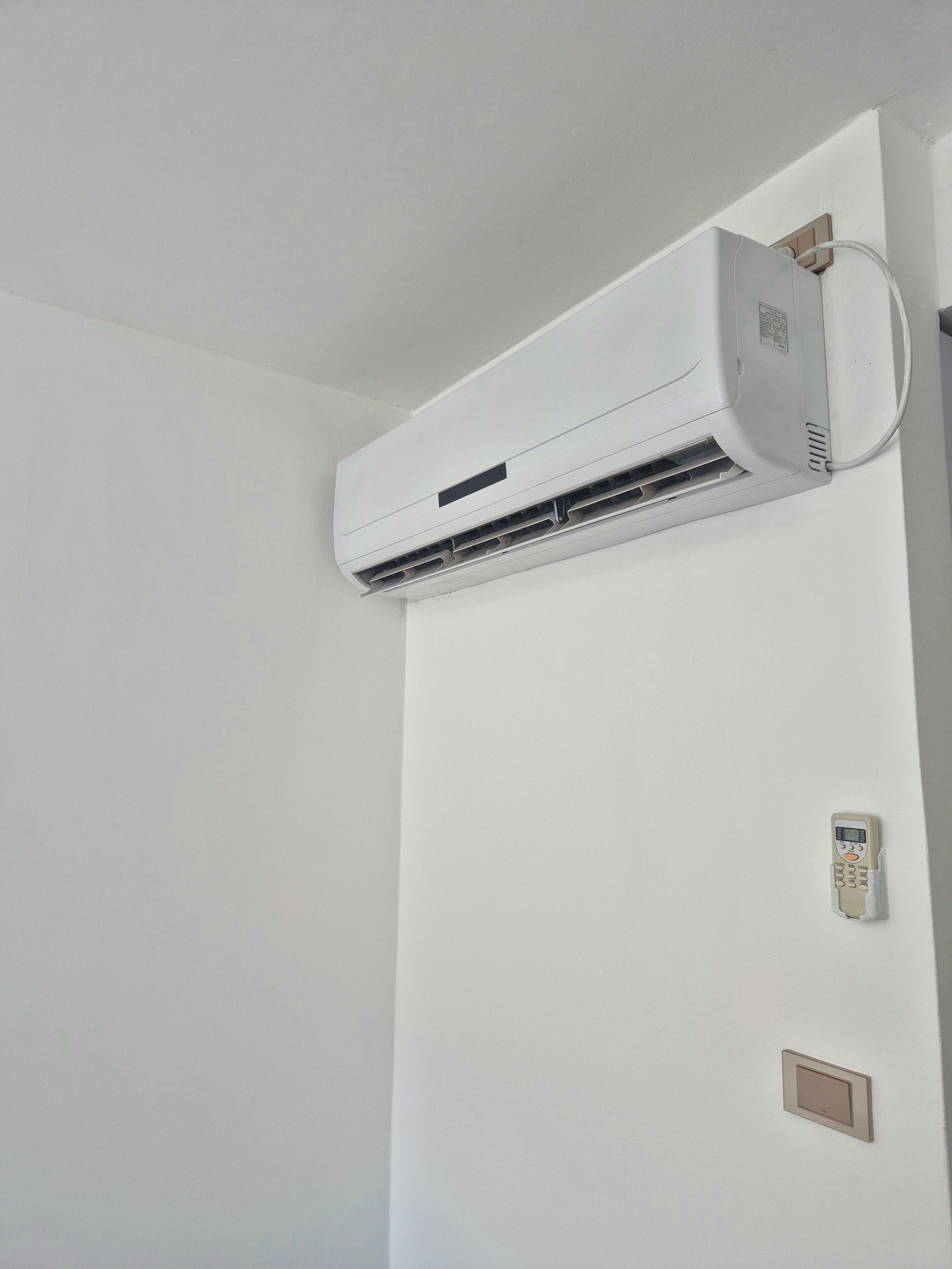 A white air conditioning unit mounted on a wall.