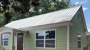 A small, single-story house with a green exterior and a sloped roof. - Cottage Suite 3 in Fort Payne (Fort Payne)