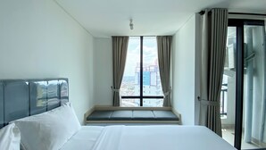 A hotel room with a large bed, a window with curtains, and a view of buildings outside. - White Toned Style Studio At Lrt City Bekasi Apartment (Bekasi)