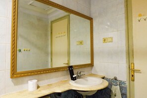A bathroom with a large mirror, a sink, and a towel rack. - Best Deal 2Br Apartment At Taman Beverly (Surabaya)