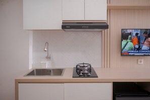 Standard Apartment | Private kitchen | Cookware/dishes/utensils - Minimalist And Warm Studio Room At Cisauk Point Apartment (Cisauk)