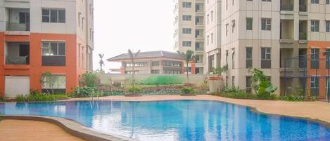 A swimming pool surrounded by high-rise residential buildings.