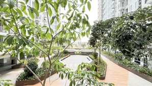 A modern indoor garden with a central water feature, surrounded by lush greenery and walkways. - Basic And Compact Studio At Tokyo Riverside Pik 2 Apartment (Teluknaga)