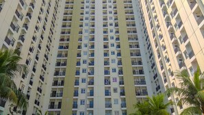 Un immeuble résidentiel de grande hauteur doté de nombreux balcons et fenêtres.