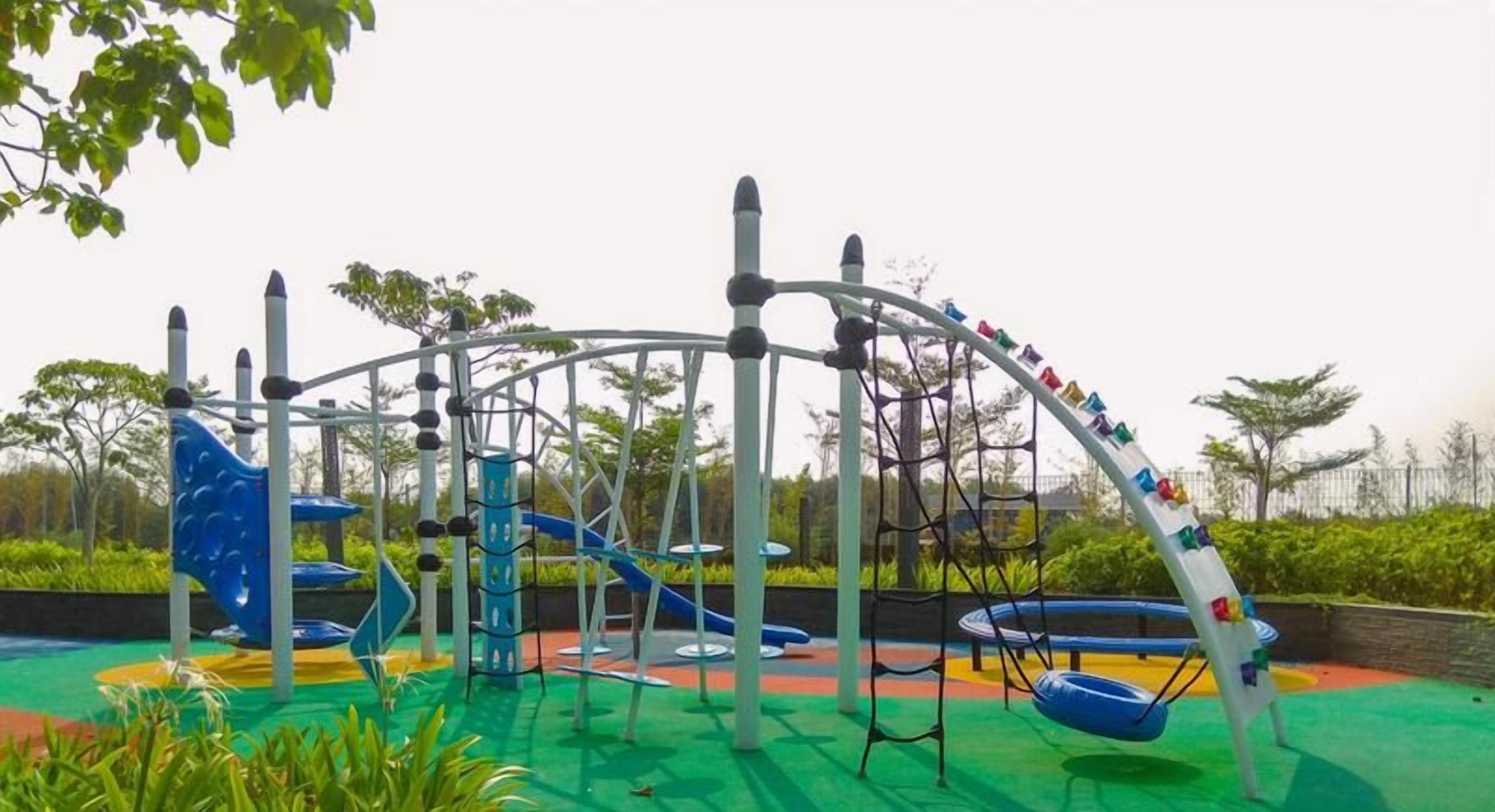 A playground with various play structures including slides and swings.
