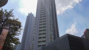 A tall, modern building with a rectangular shape and multiple floors.