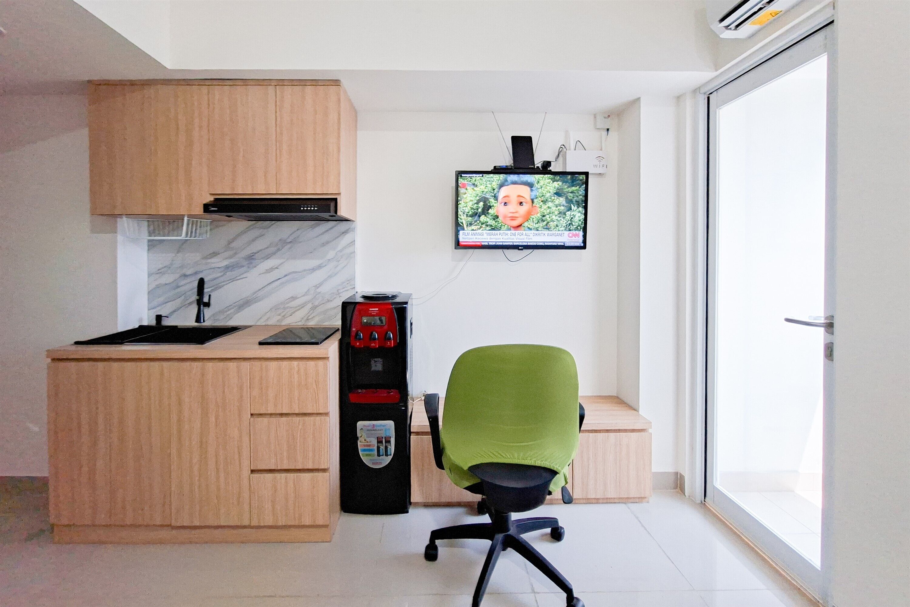 A modern kitchen with wooden cabinets, a built-in microwave, and a water dispenser.