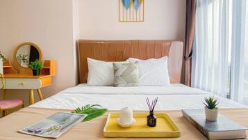 A neatly arranged hotel room with a bed, bedside table, and a window with curtains.