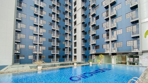 A modern building with a pool in front.