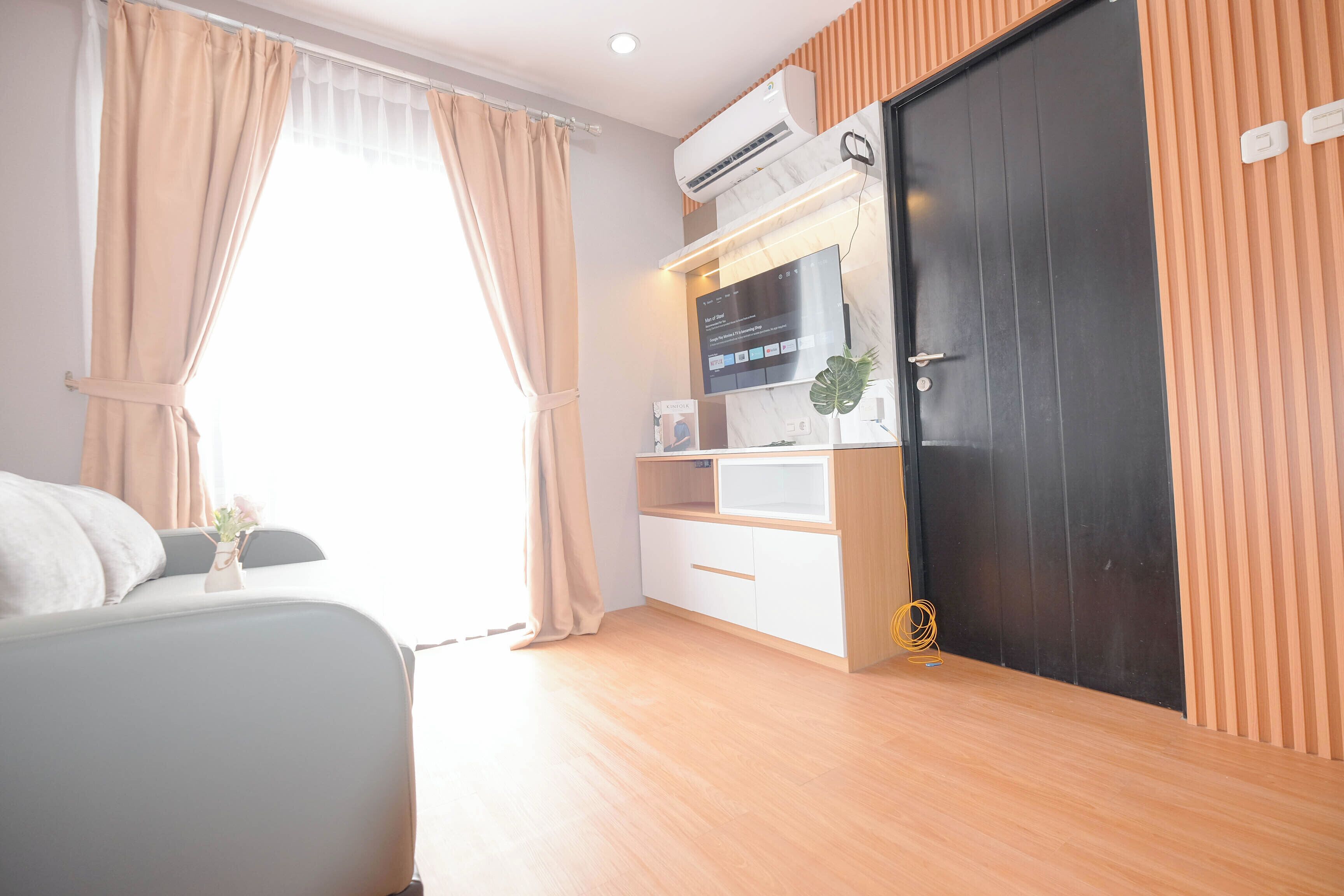 A modern bedroom with a bed, a desk, and a wardrobe.