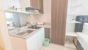 A compact kitchen with a sink, stove, and a small countertop.