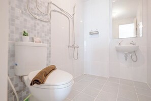 A modern bathroom with a toilet, shower, and sink. - Cozy And Spacious 2Br Apartment Tokyo Riverside Pik 2 (Teluknaga)