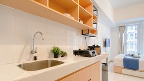 A modern kitchen with a built-in sink, wooden cabinets, and a countertop.