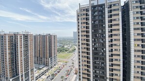 A high-rise residential building with multiple floors, balconies, and a clear view of the surrounding area.