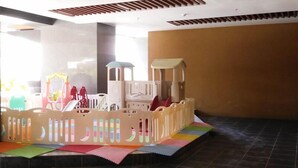 A play area with a soft play structure and colorful mats.