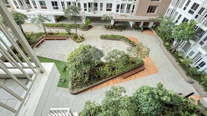 A modern residential complex with multiple buildings, landscaped courtyards, and a variety of greenery. - Modern 2Br Apartment Near Tokyo Hub At Tokyo Riverside Pik 2 (Teluknaga)