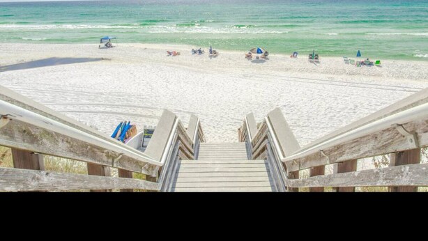 A beach with a wooden staircase leading down to the sand. - 30A Cozy Getaway - Steps to Sand! (Santa Rosa Beach)
