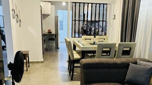 A living room with a sofa, a dining area with a table and chairs, and a kitchen in the background. - Marvelous 3-2 house for 6 Big/affordable in Aguadilla (Aguadilla)
