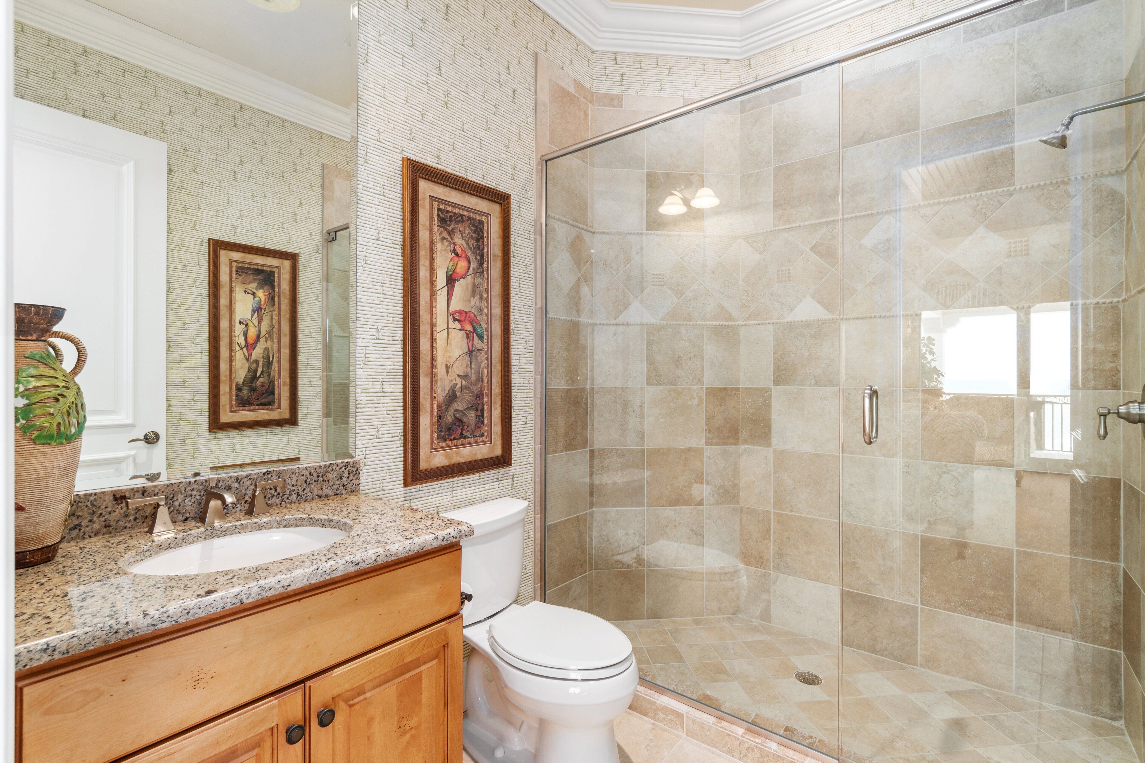 A bathroom with a sink, toilet, and shower.