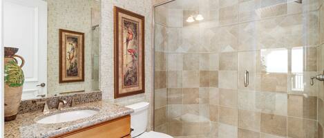 A bathroom with a sink, toilet, and shower.