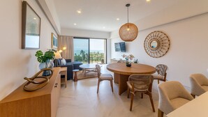 A modern living room with a dining area, large windows, and a view of the ocean. - Mar del Plata 5B (Bucerías)
