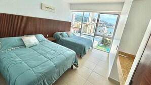 A hotel room with two beds, a view of the city, and a large window. - 3 bedroom family apartment in Acapulco, a few steps from the beach. (Acapulco de Juárez)