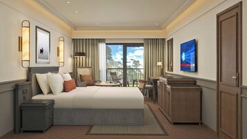 A modern hotel room with a large bed, a desk, a chair, and a TV on the wall.