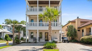 A multi-story building with balconies, a paved driveway, and a golf cart. - ✨ Elegant 6BR Beach Home | Heated Pool | Game Room | Steps to Emerald Coast 🐚 (Miramar Beach)