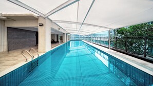 An indoor swimming pool with clear blue water, a tiled floor, and a roof structure. - Echarm International Hotel Guangzhou Huangpu Flagship Branch (Guangzhou)