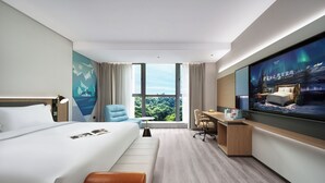 A modern hotel room with a large bed, a desk, a chair, and a television. - Echarm International Hotel Guangzhou Huangpu Flagship Branch (Guangzhou)